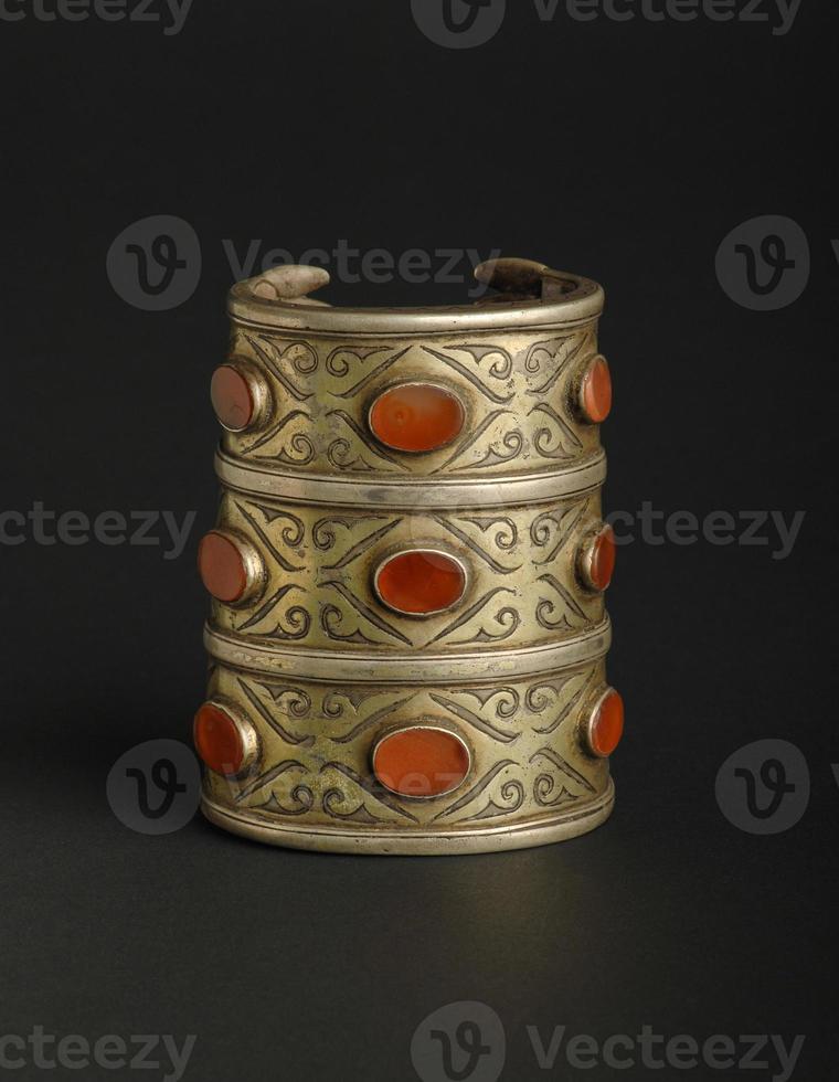 ancient antique bracelet with stones on black background. Middle Asian vintage jewelry photo