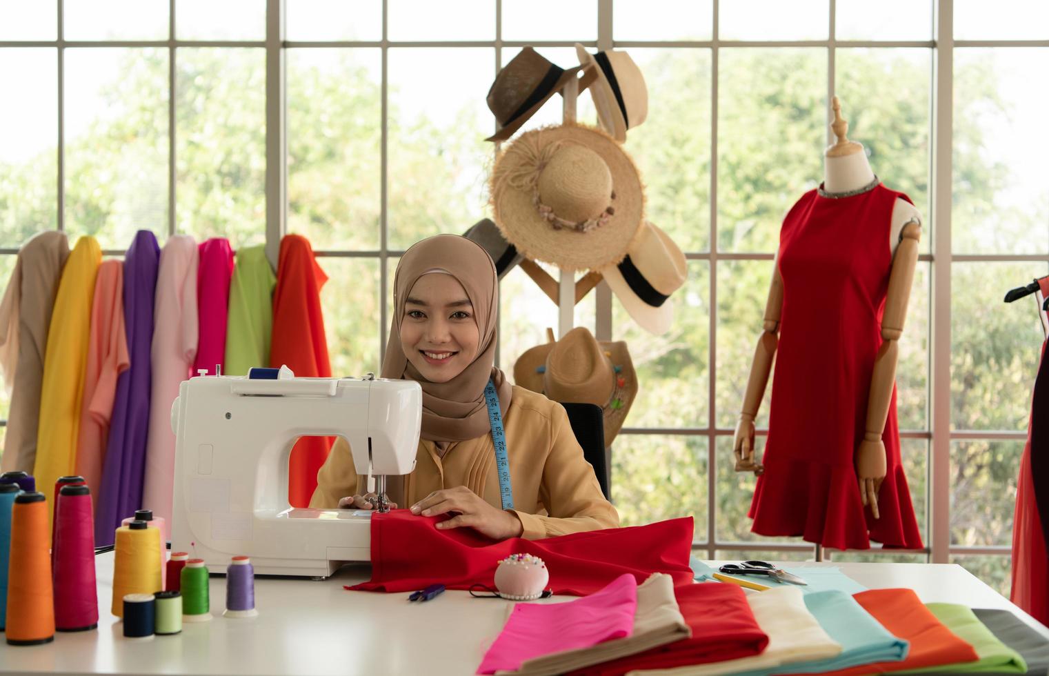 Muslim women run a small business in their own homes. Is the design and tailoring of clothes. photo