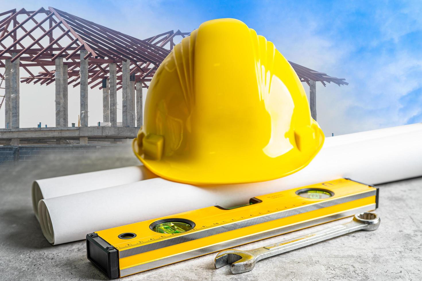 Safety first hard helmet hat and engineer tool at construction estate site background. photo