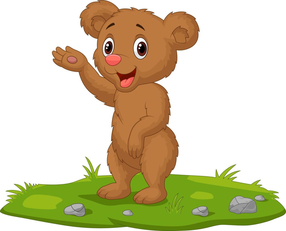 Cute baby bear waving hand on the grass vector