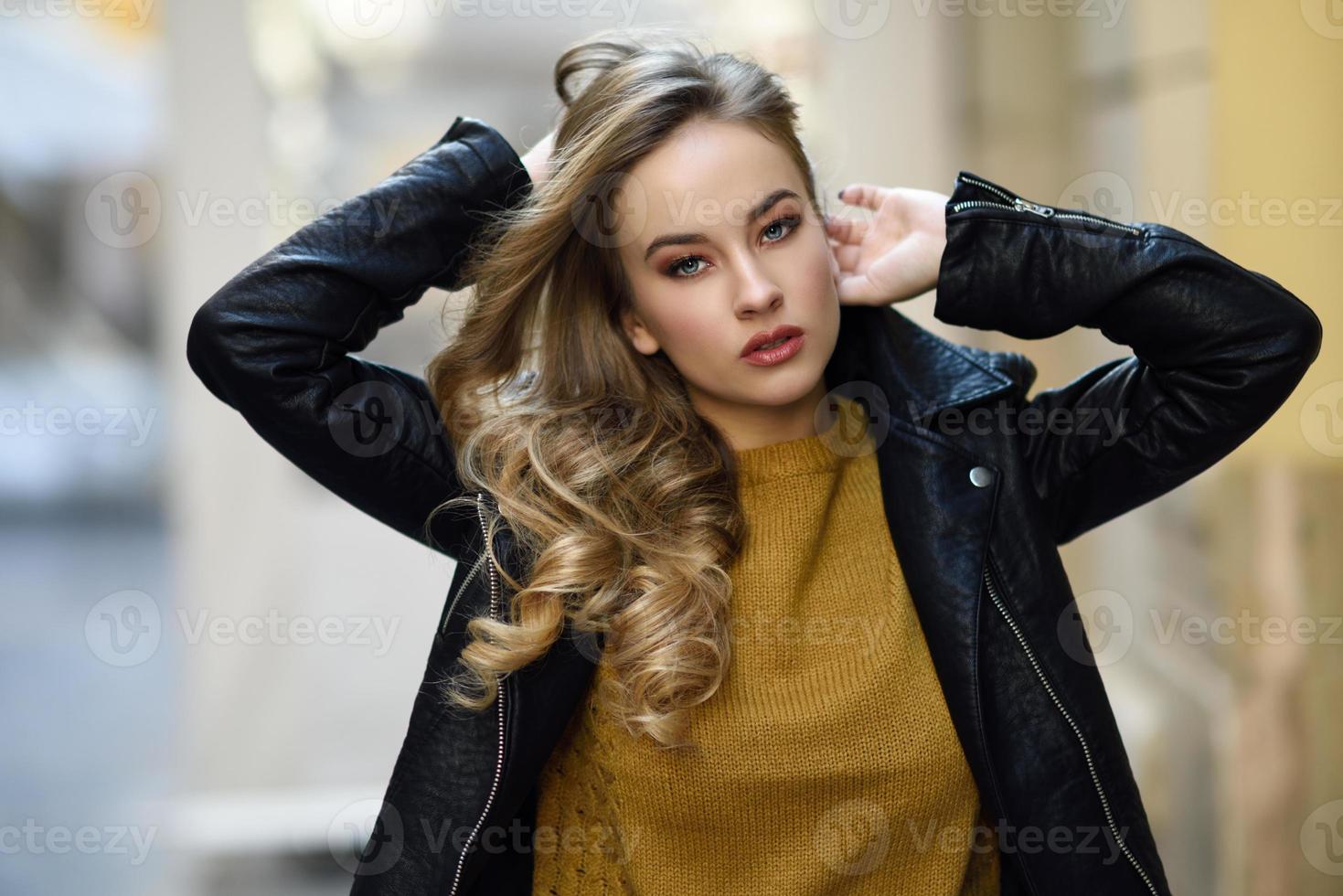 Beautiful blonde russian woman in urban background photo