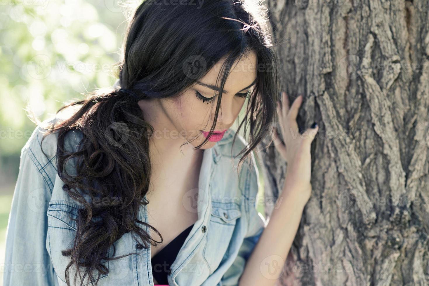 Young beautiful woman in a park photo
