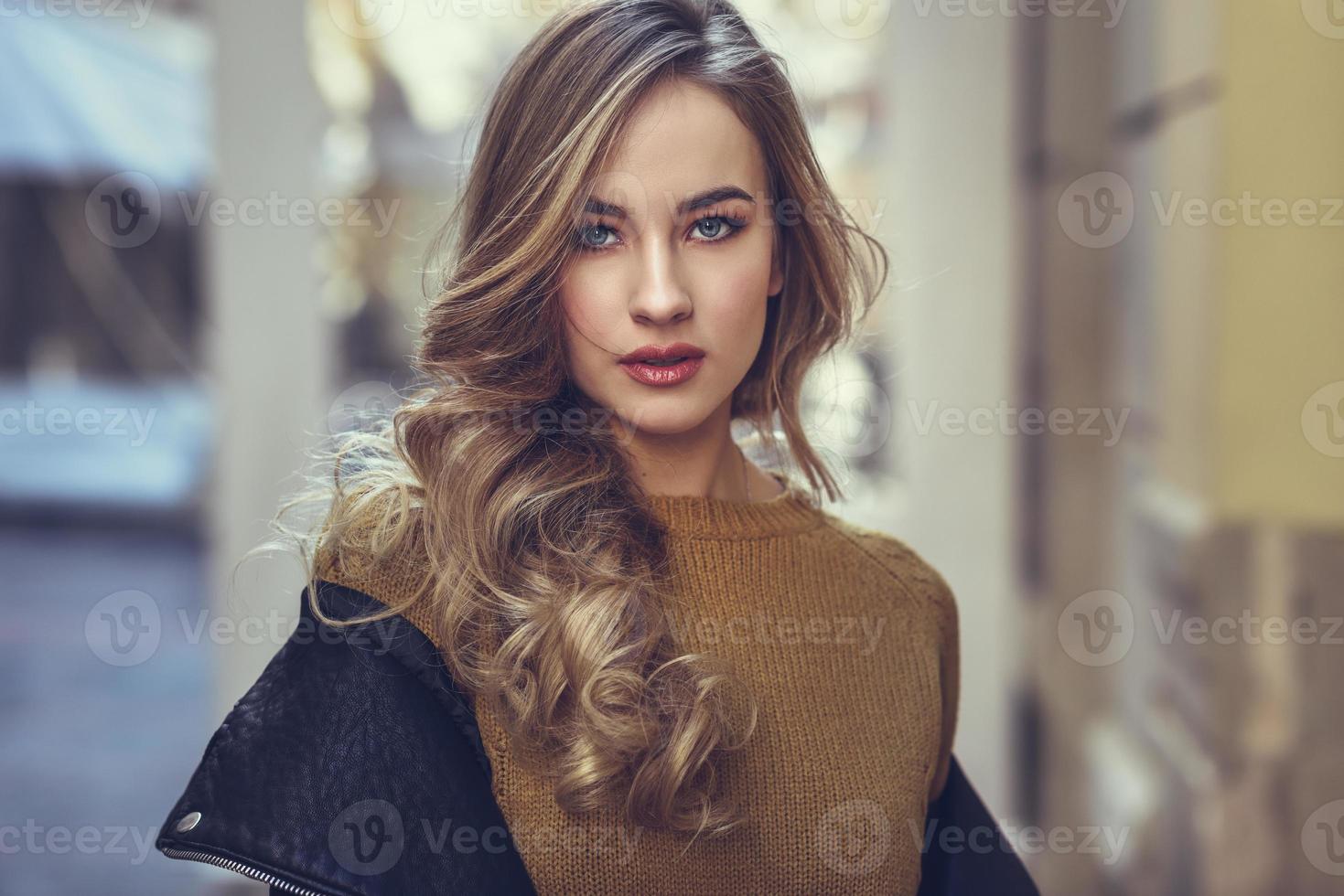 Beautiful blonde russian woman in urban background photo