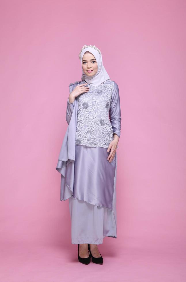 Full body portrait of lady use a wedding dress, wedding makeup on hijab. Malay or indonesia wedding dress, beauty or eidul fitri concept. Beautiful southeast asian muslim woman posing in islam dress photo