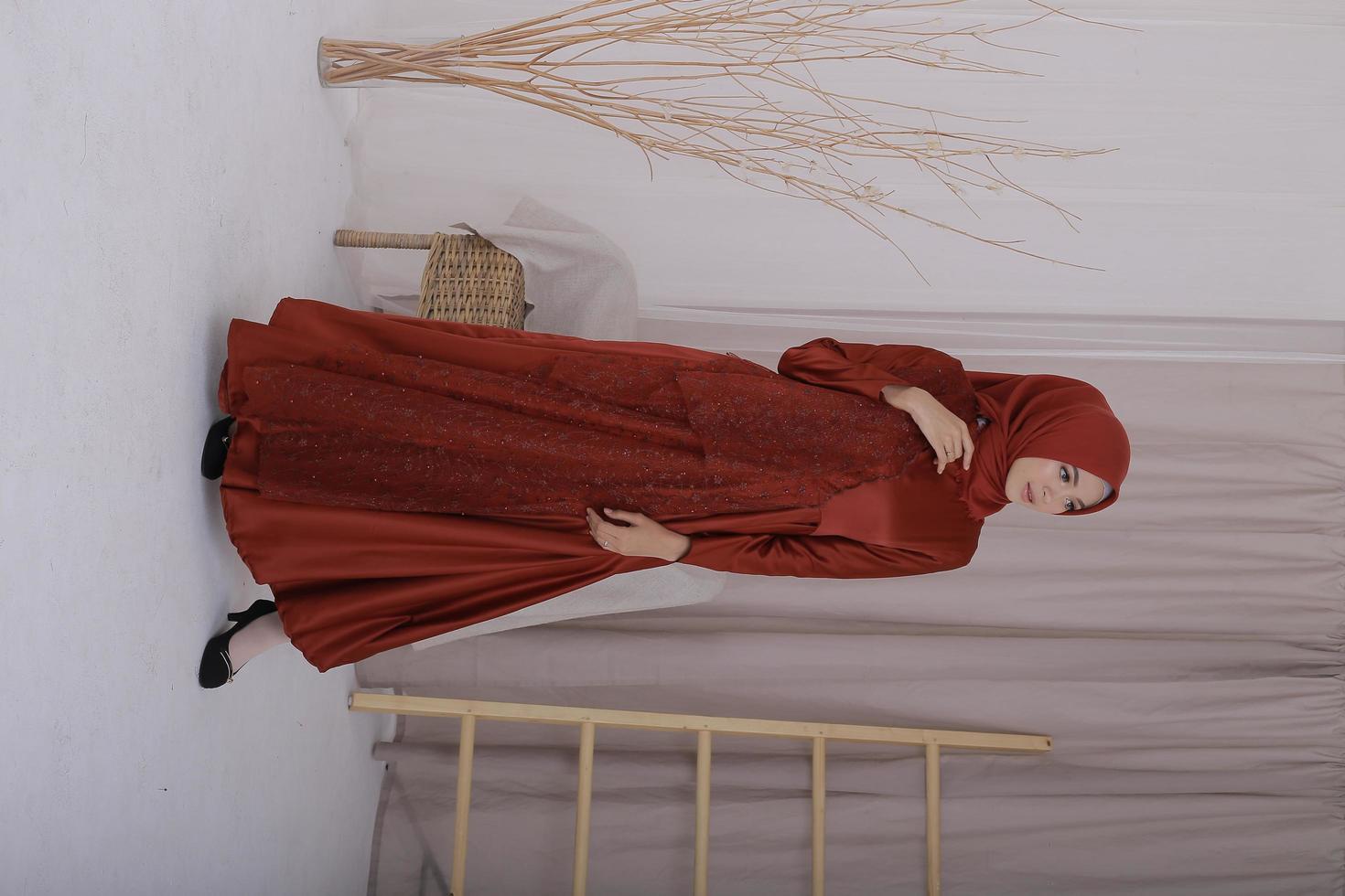 Beautiful islamic female model wearing hijab fashion, a modern lifestyle outfit for muslim woman. Concept a wedding dress, beauty or eidul fitri. A asian girl model wearing hijab on indoor photoshoot photo