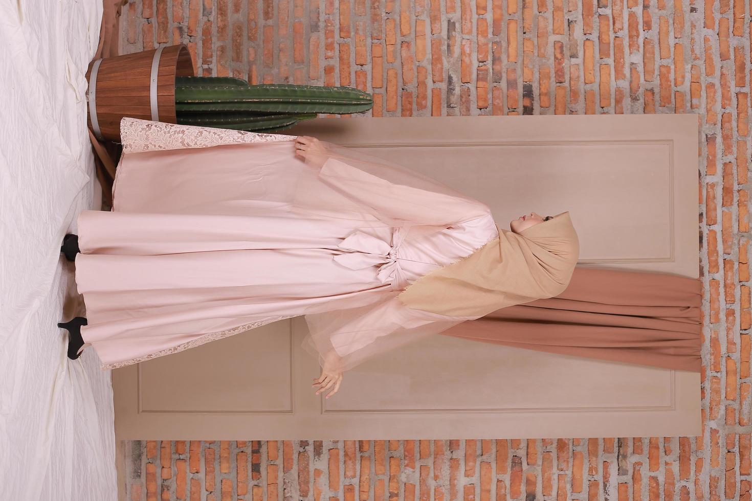 Beautiful islamic female model wearing hijab fashion, a modern lifestyle outfit for muslim woman. Concept a wedding dress, beauty or eidul fitri. A asian girl model wearing hijab on indoor photoshoot photo