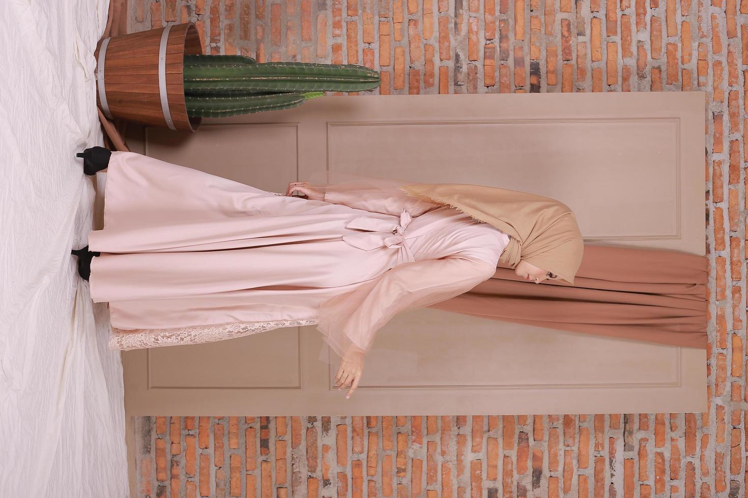 Beautiful islamic female model wearing hijab fashion, a modern lifestyle outfit for muslim woman. Concept a wedding dress, beauty or eidul fitri. A asian girl model wearing hijab on indoor photoshoot photo