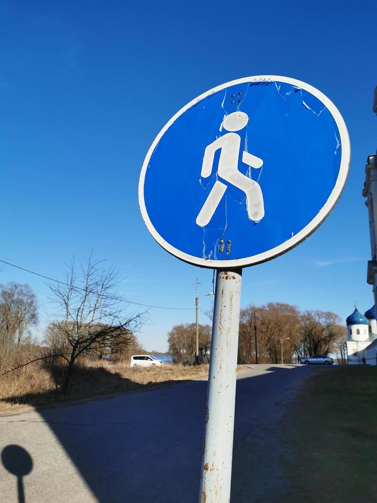 road sign pedestrian zone close-up on a background of blue sky photo