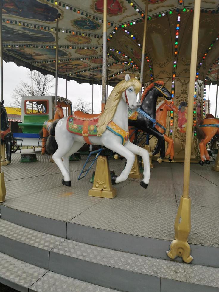 Carousel round in the Park in the spring.Horse on a roundabout.Fun, fair, recreation, children photo