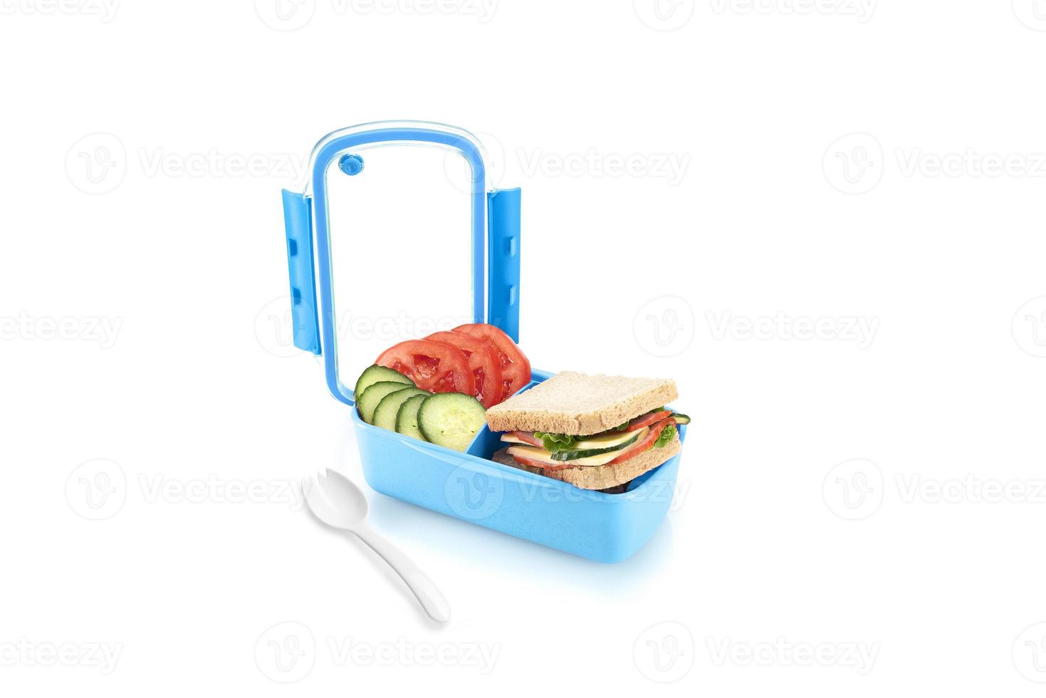 Healthy blue lunch box with sandwiches and vegetables for kids. Isolated on white background. photo