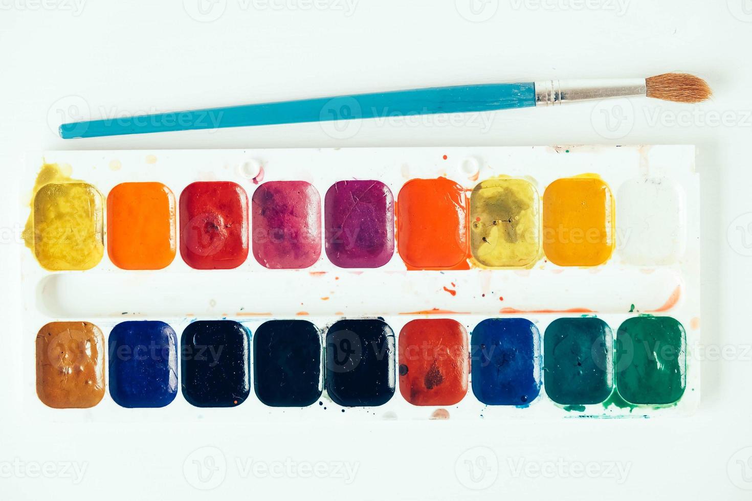 Set of watercolor paints and brushes for painting on a white background photo