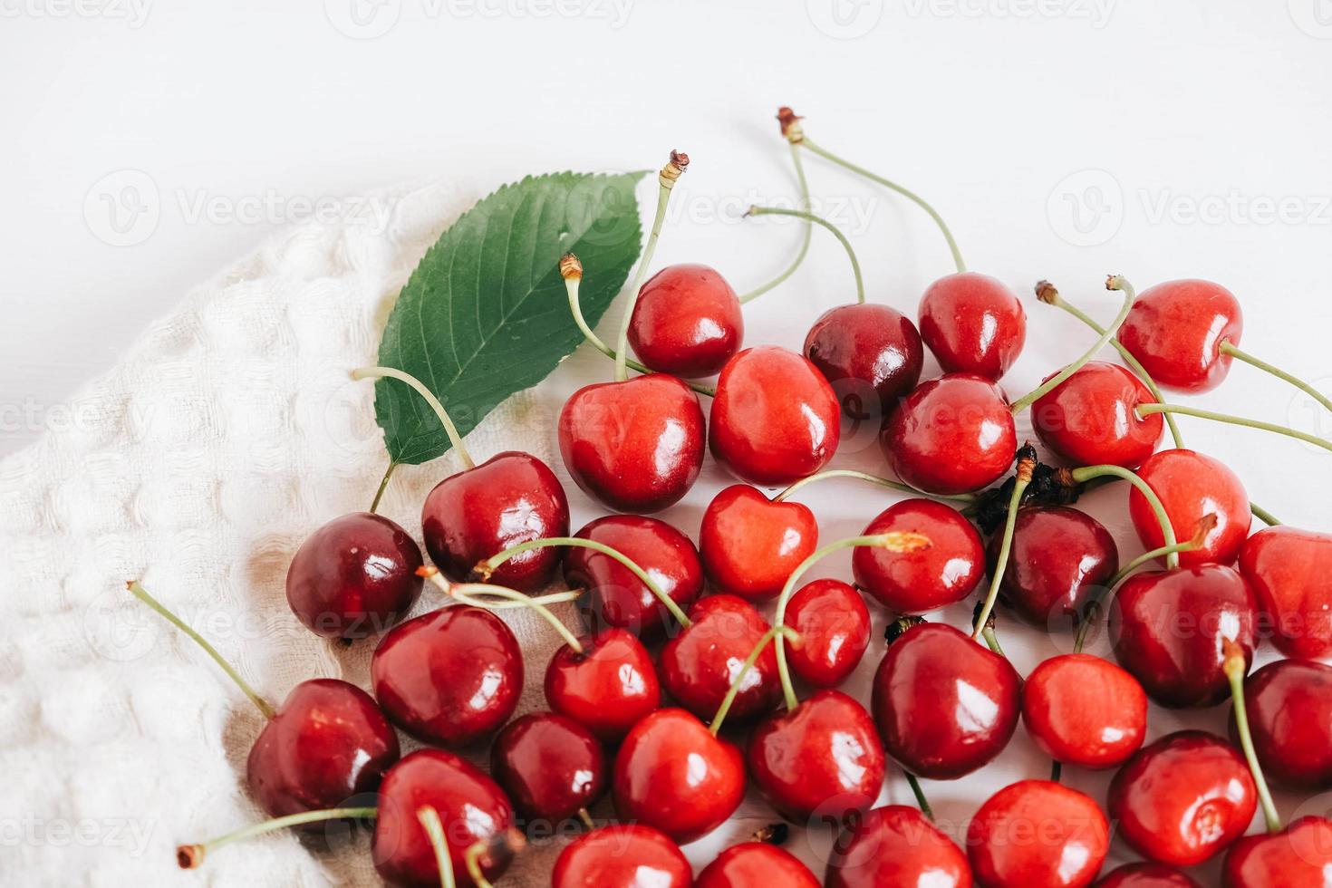 Fresh ripe cherry on white wooden background photo