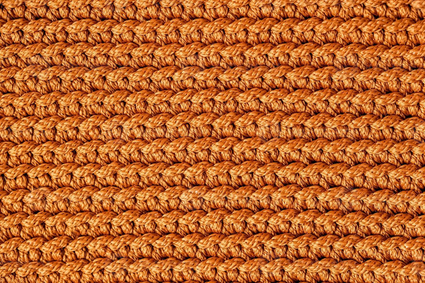 Orange knitted fabric texture background photo