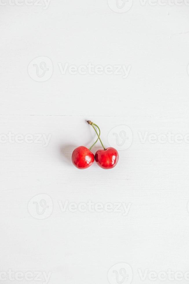 Fresh ripe cherries on the white wooden background. Top view. Copy, empty space for text photo