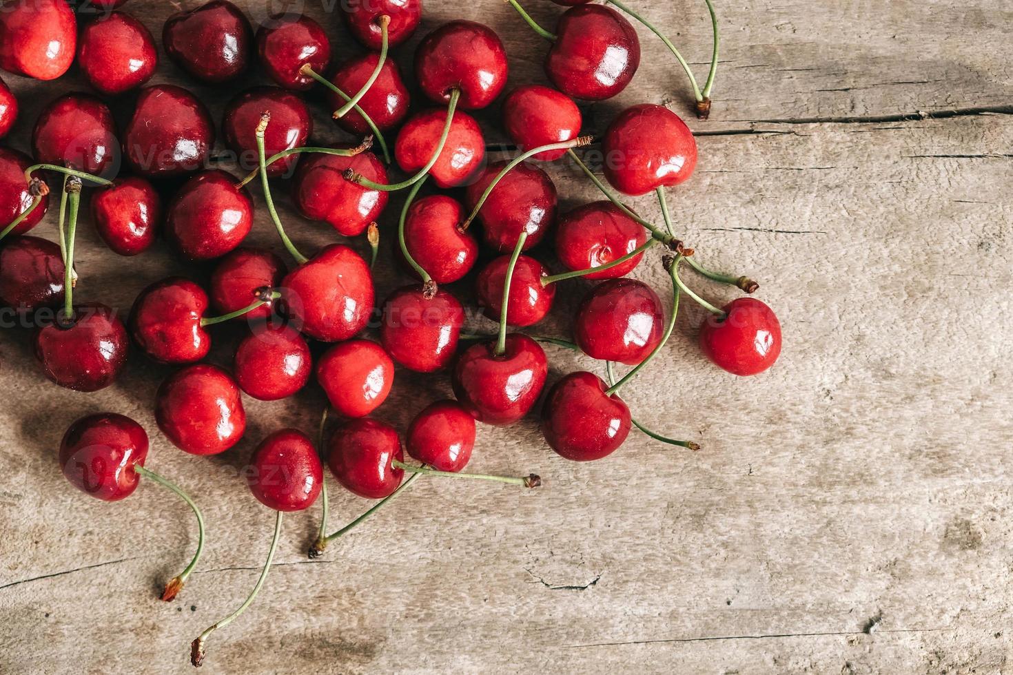 Fresh ripe cherries on wooden background.Top view. Copy, empty space for text photo