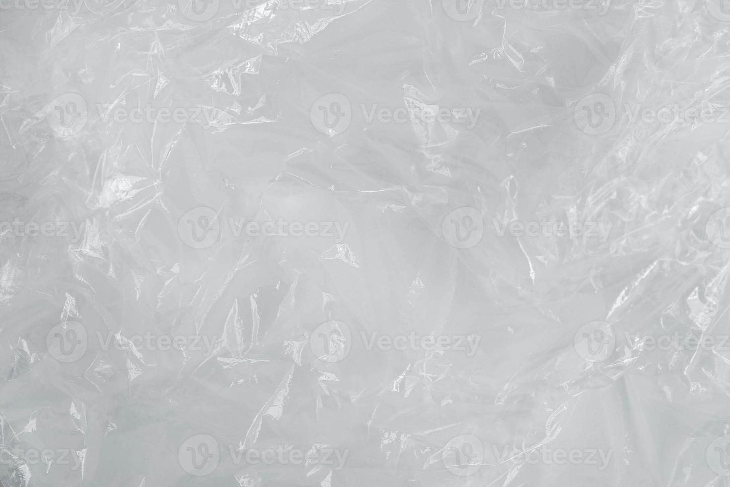 Wrinkled transparent plastic texture on a white background. Transparent packaging film. Top view. Copy, empty space for text photo