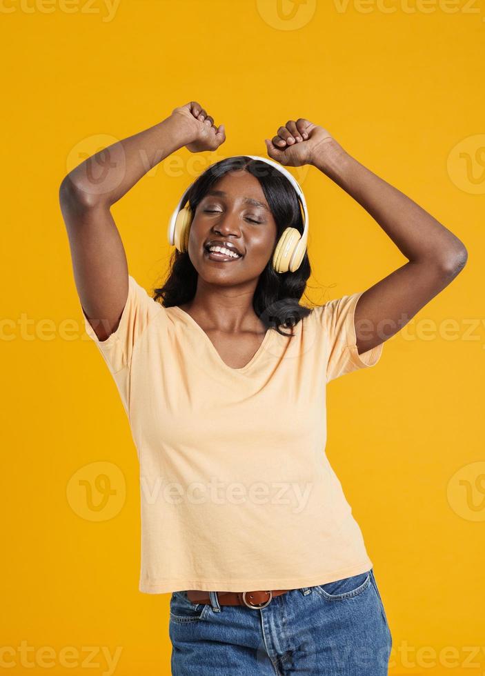 Happy African woman dancing with headphones photo