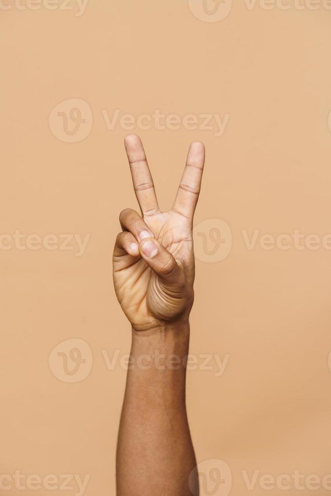 African male fingers showing peace or victory photo