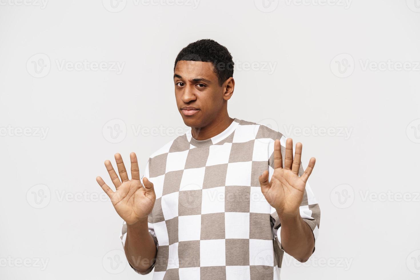 Confused African man showing stop gesture photo