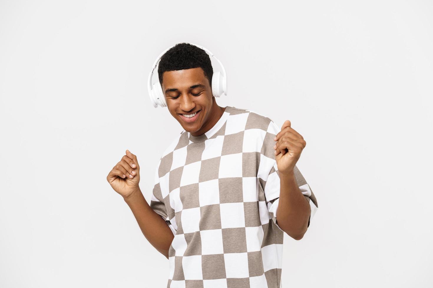 Happy African man dancing with headphones photo