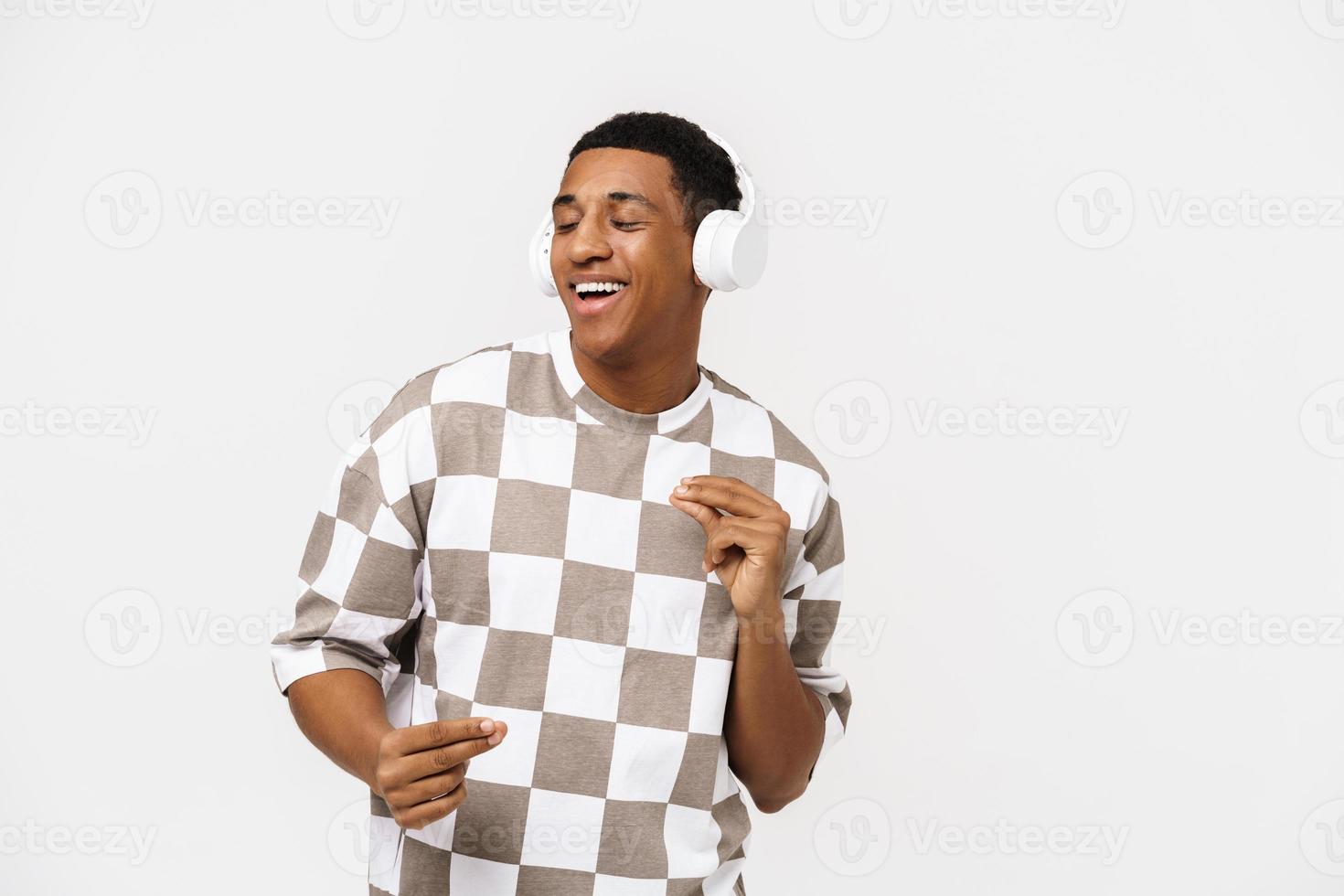 Cheerful African man dancing and singing with headphones photo