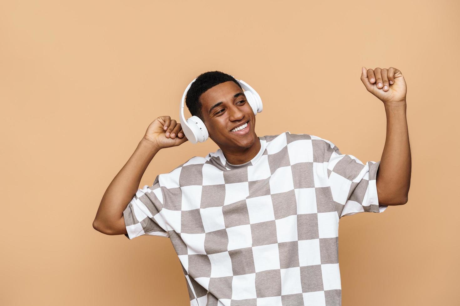 Handsome positive man dancing with headphones photo