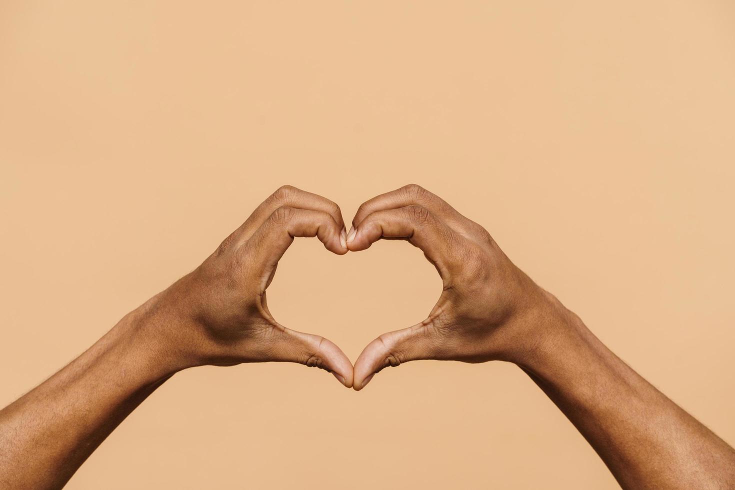 manos masculinas africanas que muestran una forma de corazón foto