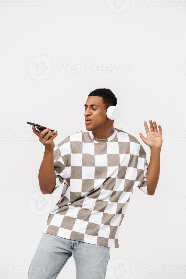Handsome African man singing with headphones photo