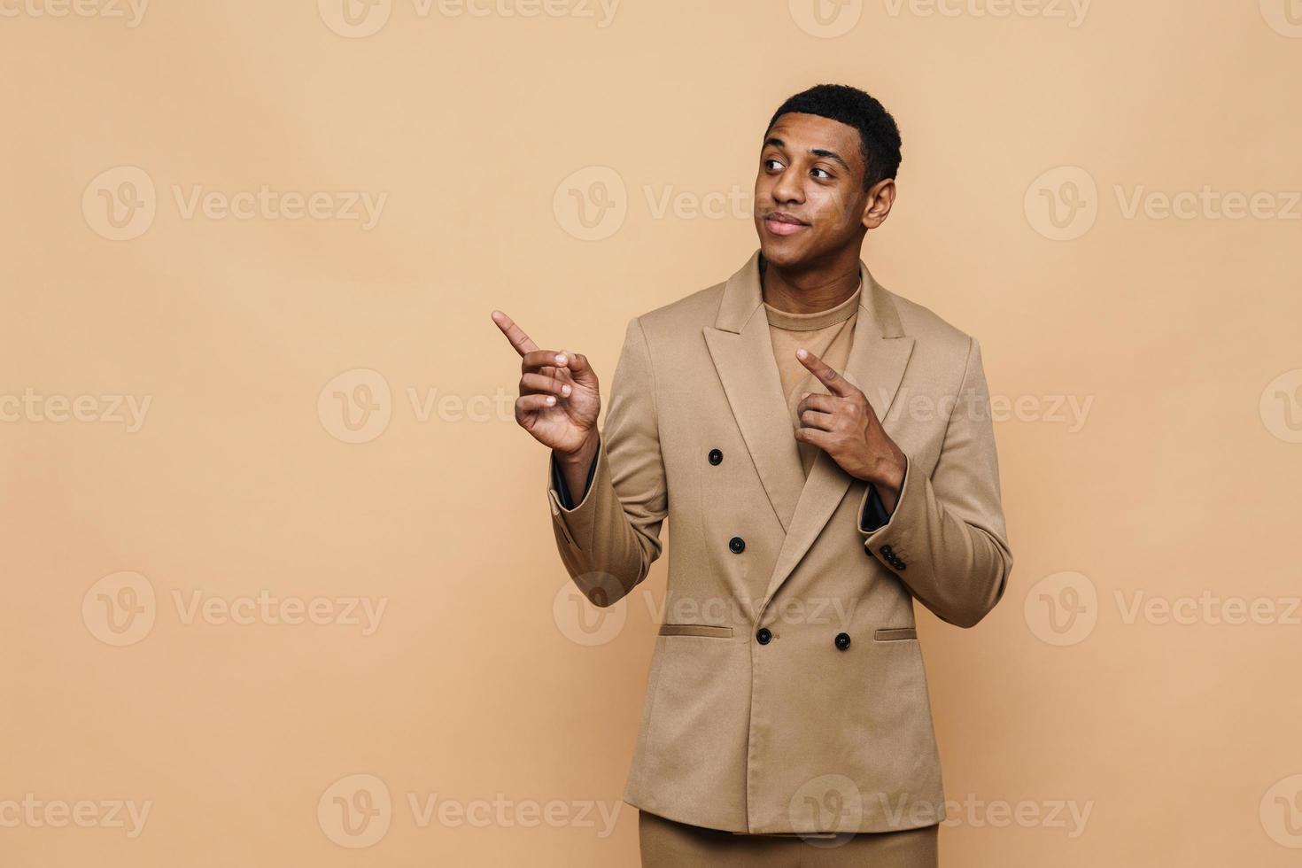 Positive African businessman pointing to the side photo