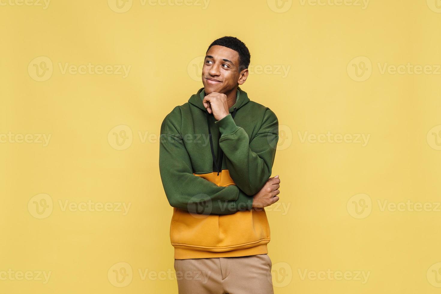 Pensive African man in hoodie looking to the side photo