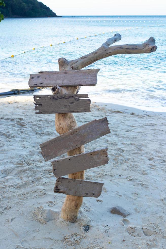 Empty wooden sign on the beach photo