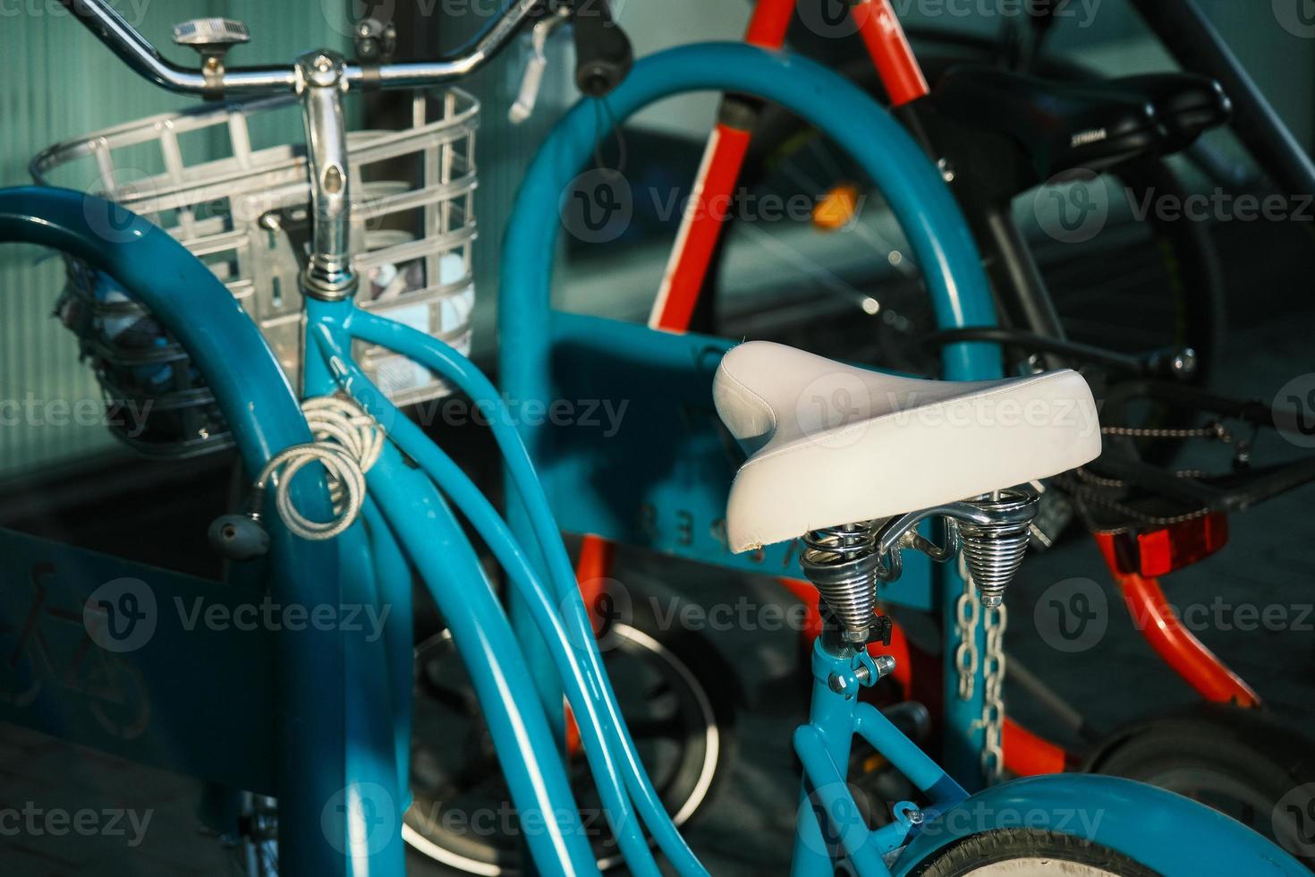 blue retro bicycle on the modern parking row of a mall photo