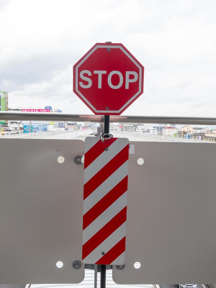 On the BTS station BANGKOKTHAILAND17 AUGUST 2018 Red lettering stop sign on17 AUGUST 2018 in Thailand. photo