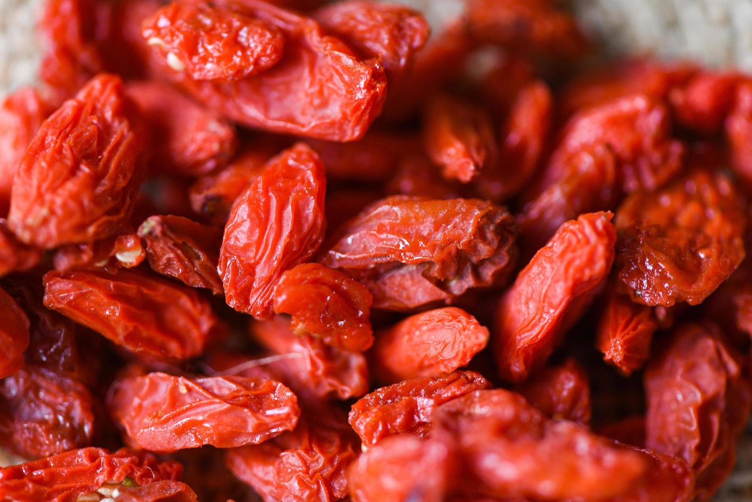 goji berry dry spices and herbs food ingredients - goji berries on background photo