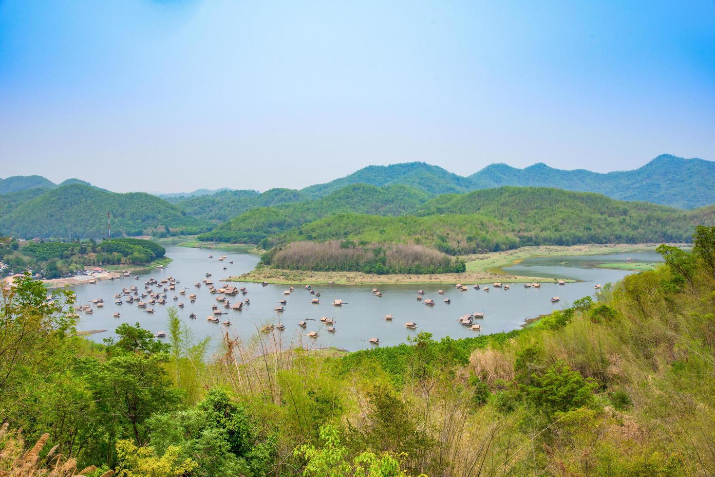 Mountain lake landscape of river green mountain with bamboo houseboat raft floating looking from viewpoint photo