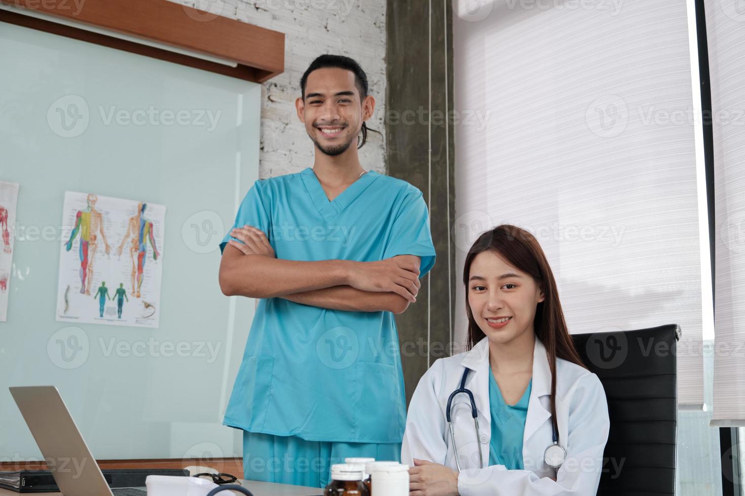 equipo de socios de atención médica, retrato de dos jóvenes médicos de origen asiático en uniforme con estetoscopio, sonriendo y mirando a cámara en la clínica, personas con experiencia en tratamiento profesional. foto
