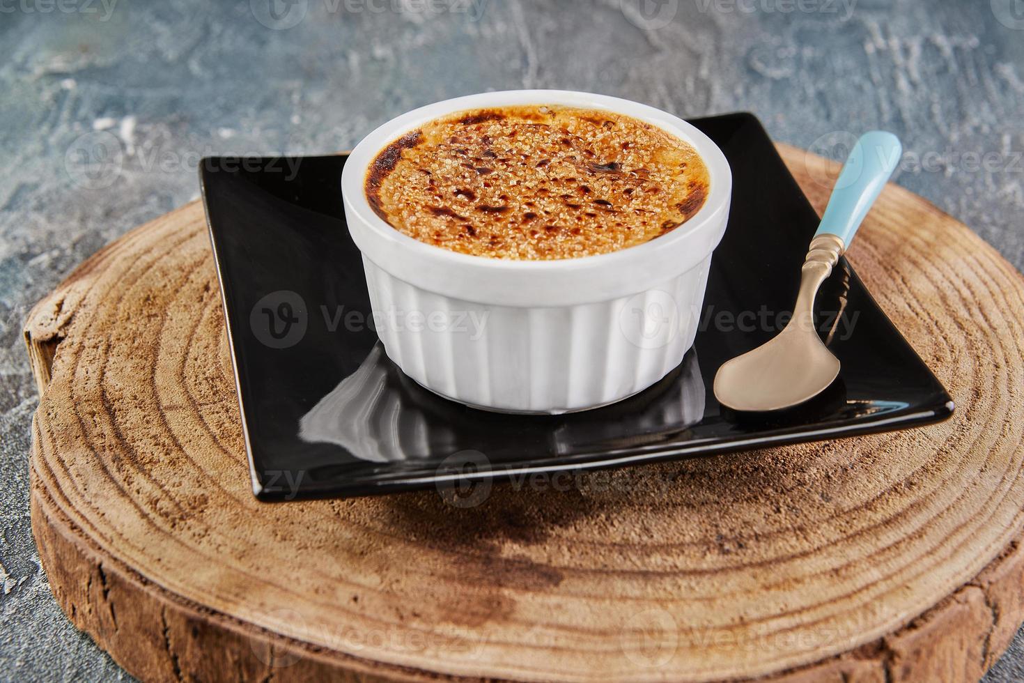 Creme brulee with mushrooms in special form on plate with spoon photo