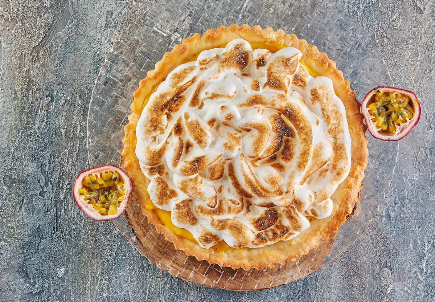 Passion flower pie on plate with pasiflora halves. French gourmet cuisine photo