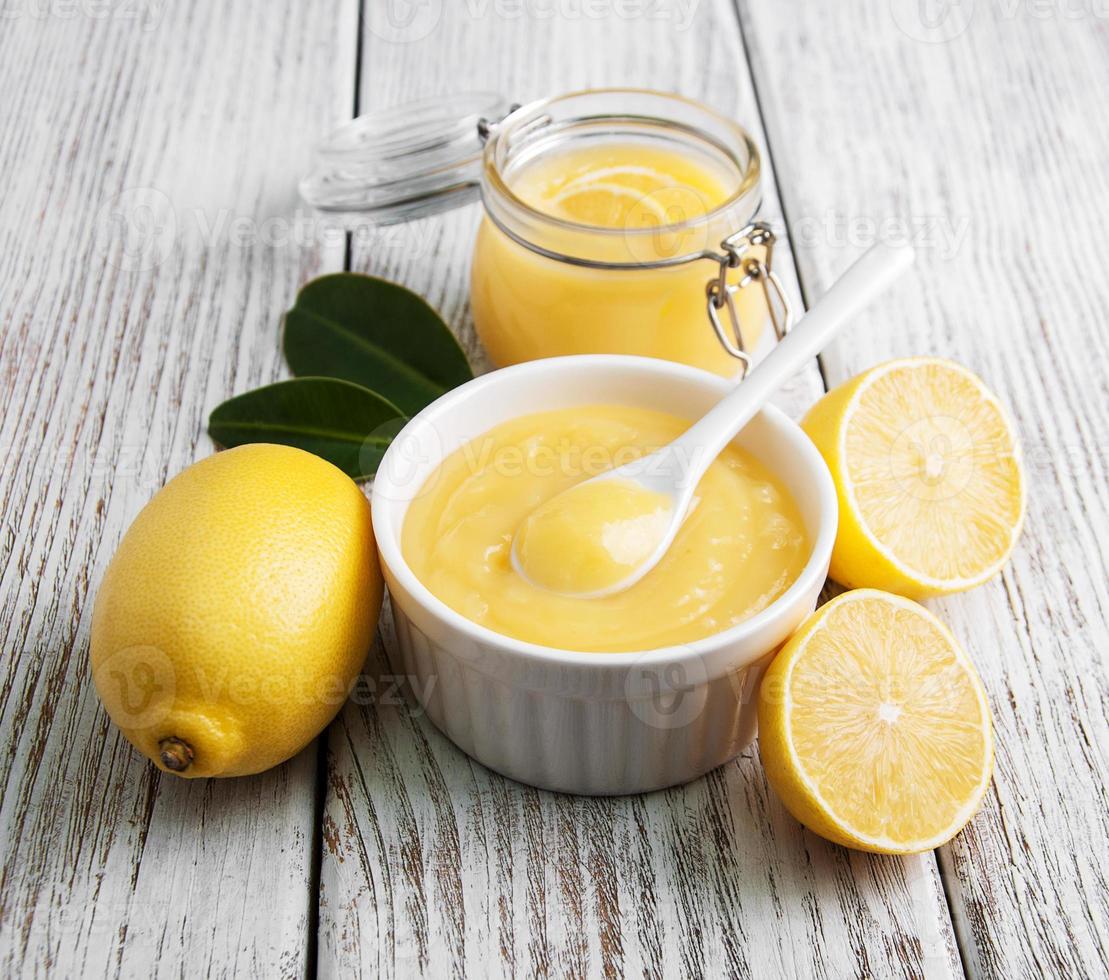 Lemon curd and fresh lemons photo