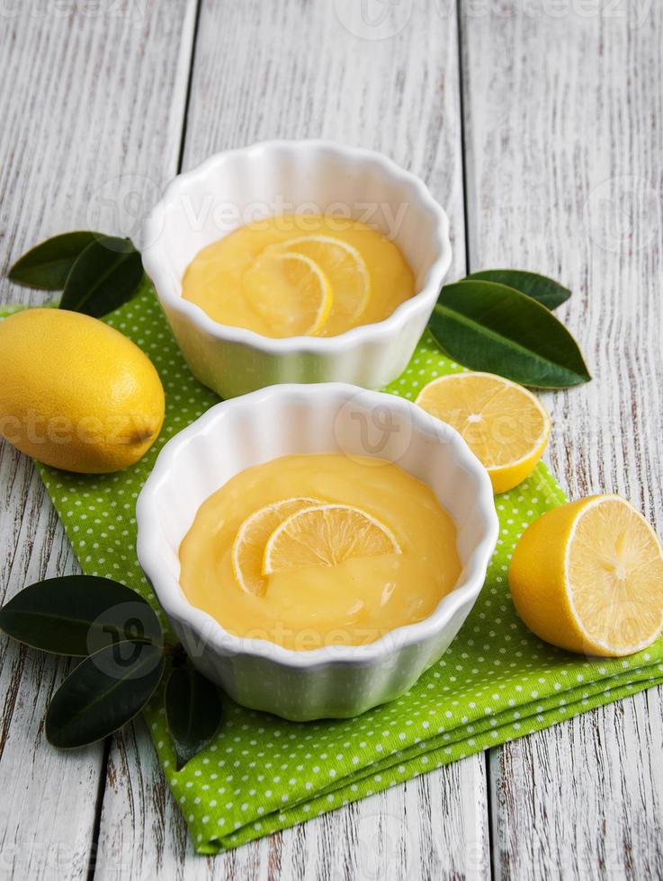 Lemon curd and fresh lemons photo