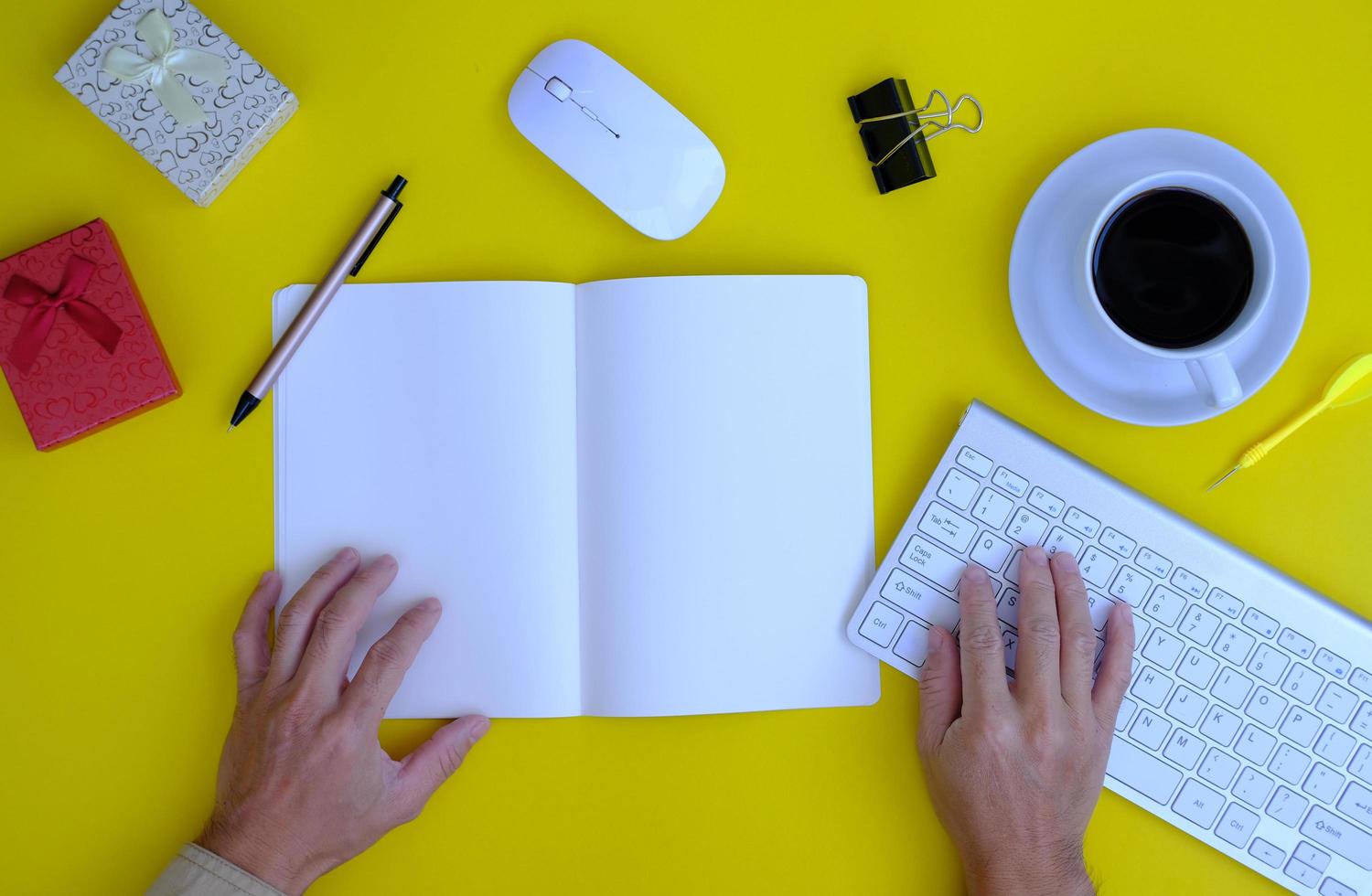 keyboard computer, smartphone with a blank screen, a notebook, are shown on a modern office desk table. Flat lay, top view with copy space photo