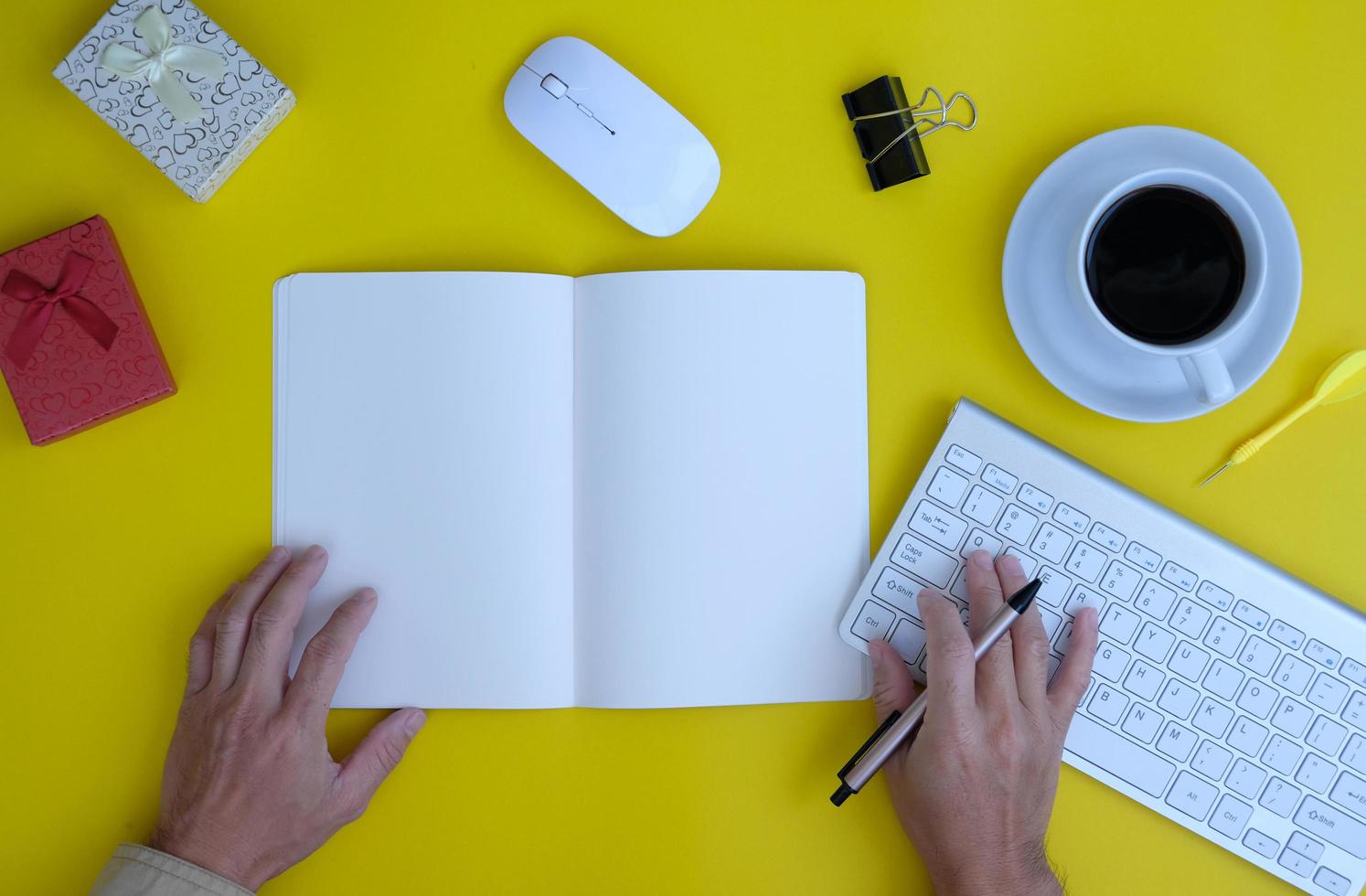 keyboard computer, smartphone with a blank screen, a notebook, are shown on a modern office desk table. Flat lay, top view with copy space photo