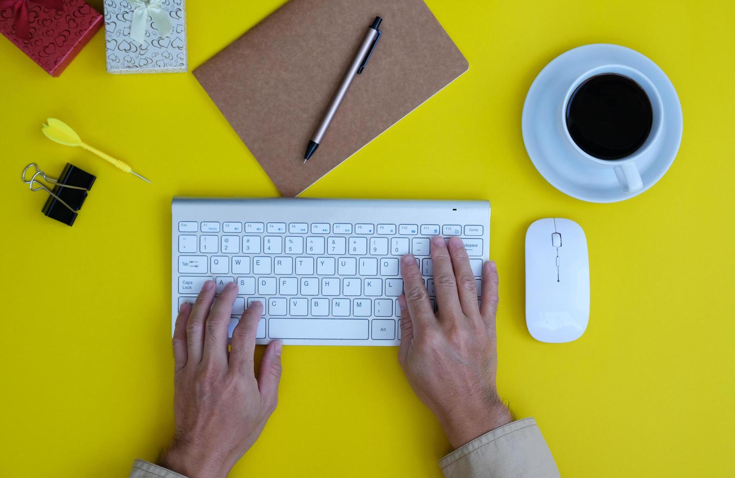 keyboard computer, smartphone with a blank screen, a notebook, are shown on a modern office desk table. Flat lay, top view with copy space photo