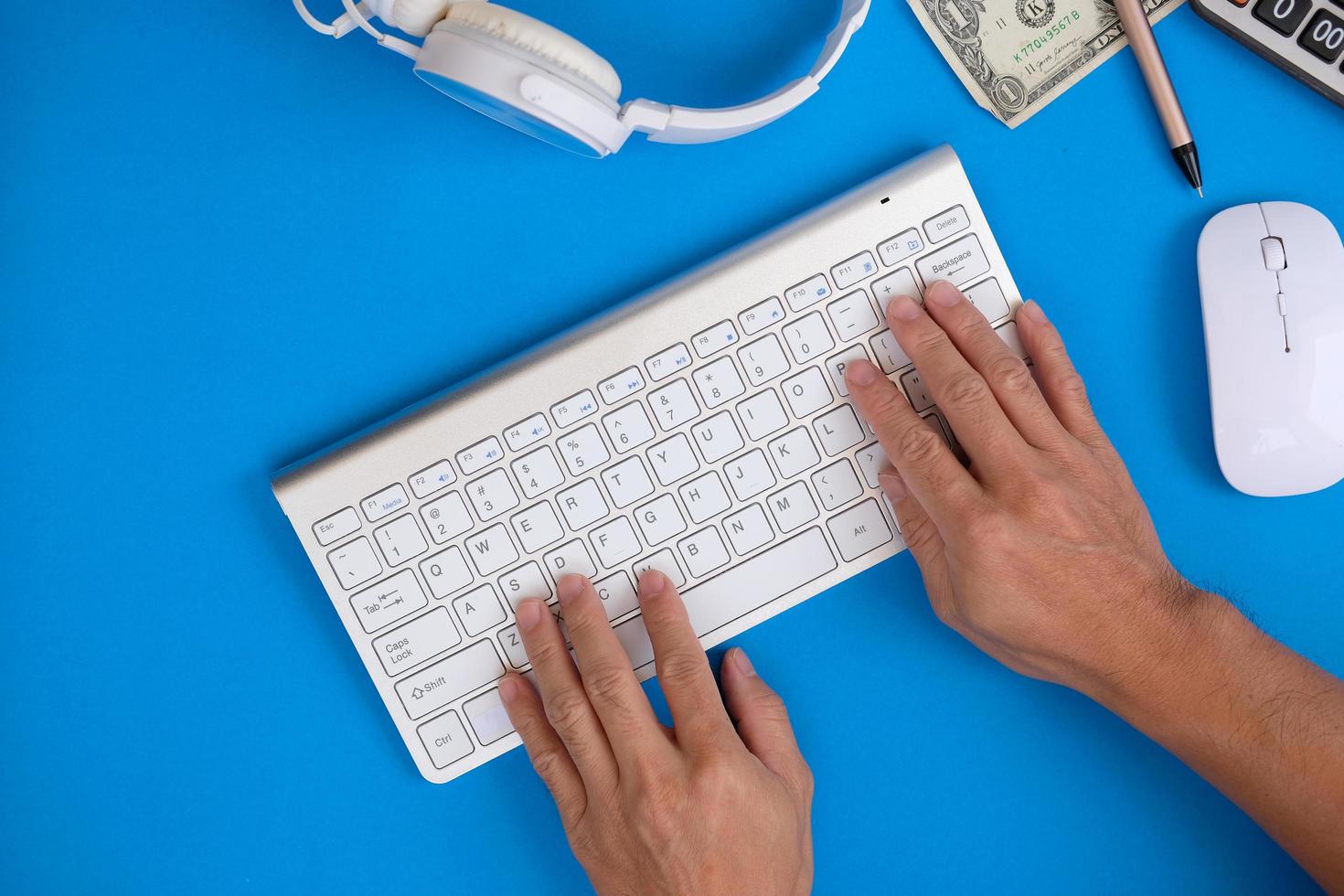 At a desk, a businessman is using a laptop computer, while a businessman is working in his office. Freelancing, student life, e-learning, studying, web site, and technology are all topics that come up photo
