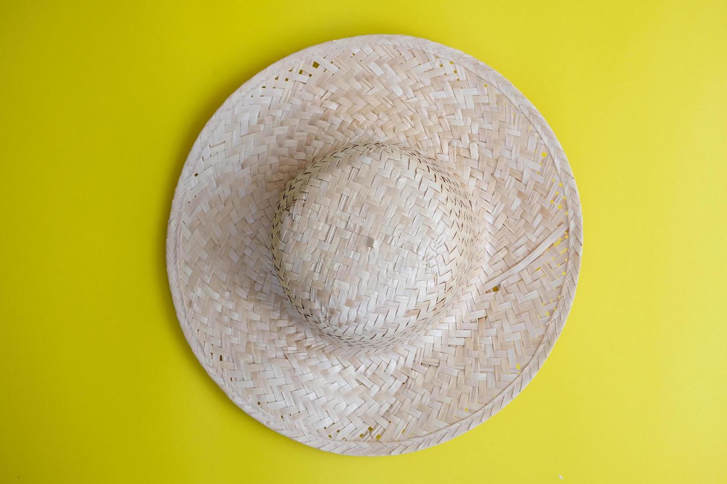 Women's sun hats against a yellow background, beach fashion photo