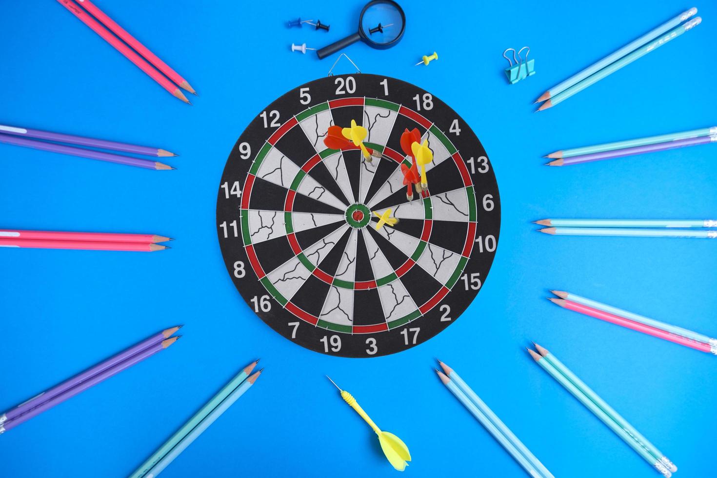 Dart board and a desk. Workspace with a target and a successful business growth concept, as well as a dart board with a target. photo