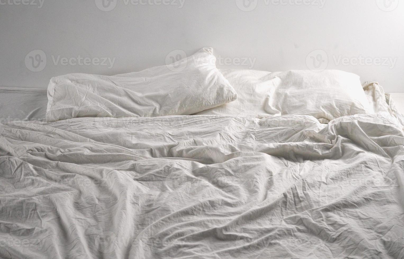 Unmade bed sheets photo