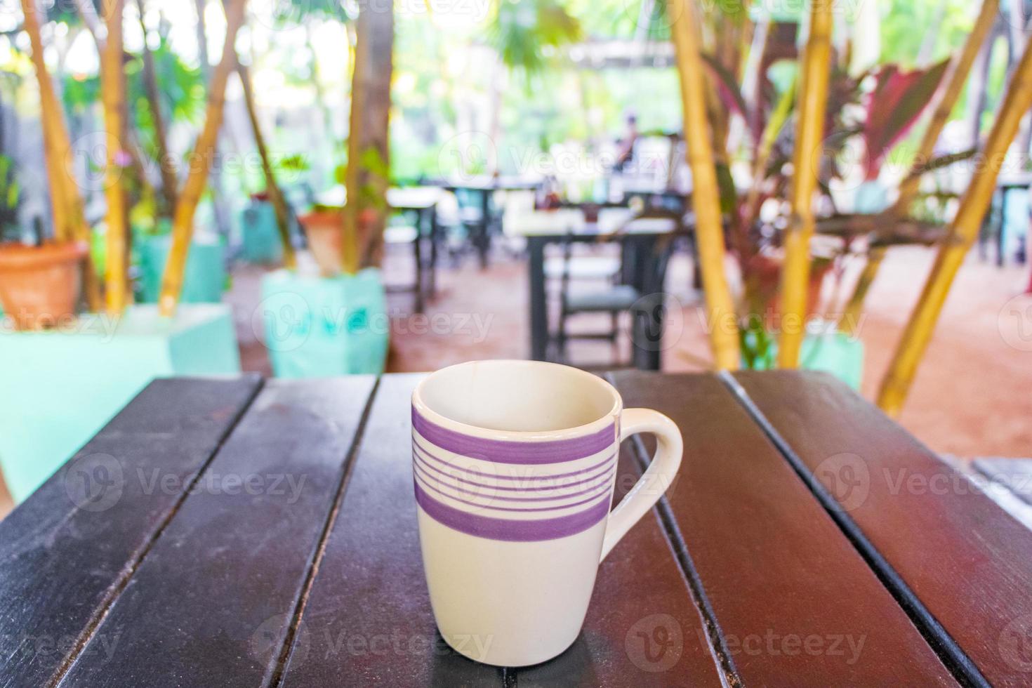 Coffee on brown wooden table on tropical Holbox island Mexico. photo