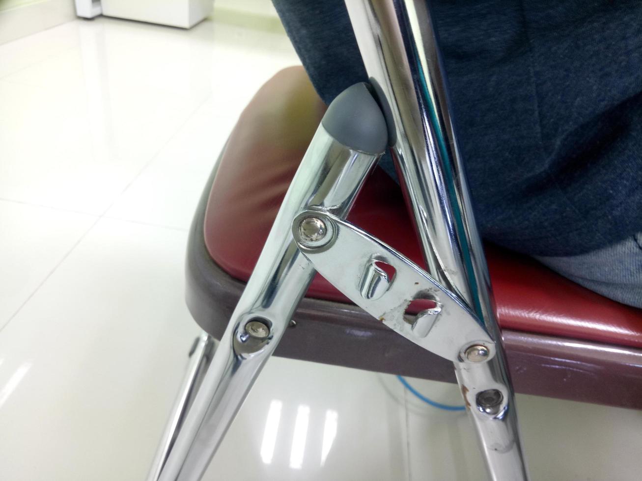 folding chair frame made of metal. folding chairs are often used in university classes photo
