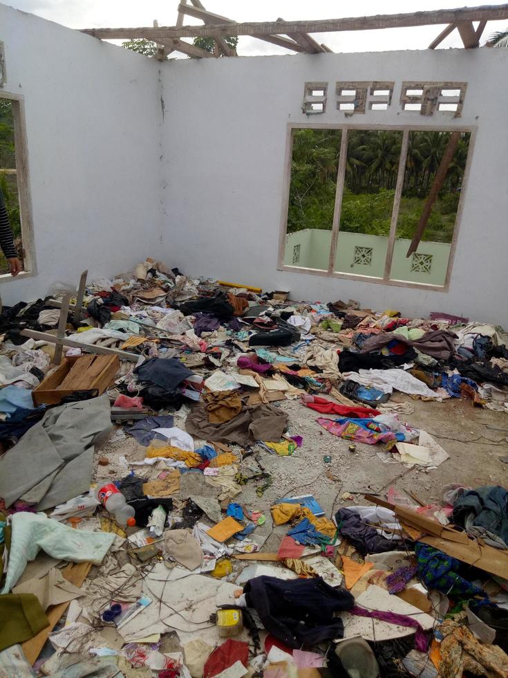 clothes scattered in the house that was destroyed by the earthquake photo